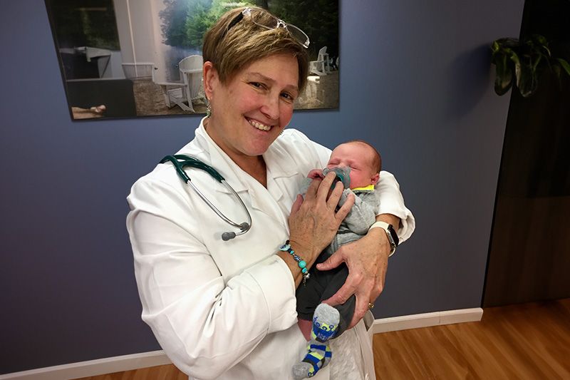 Dr. Casey holding a baby