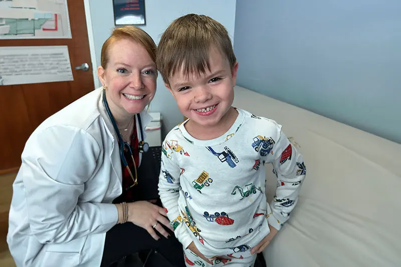 Dr. Bandari with smiling young child