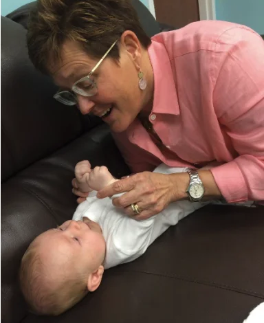 Dr. Casey playing with a baby