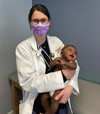 Dr. Silverstein holding a baby